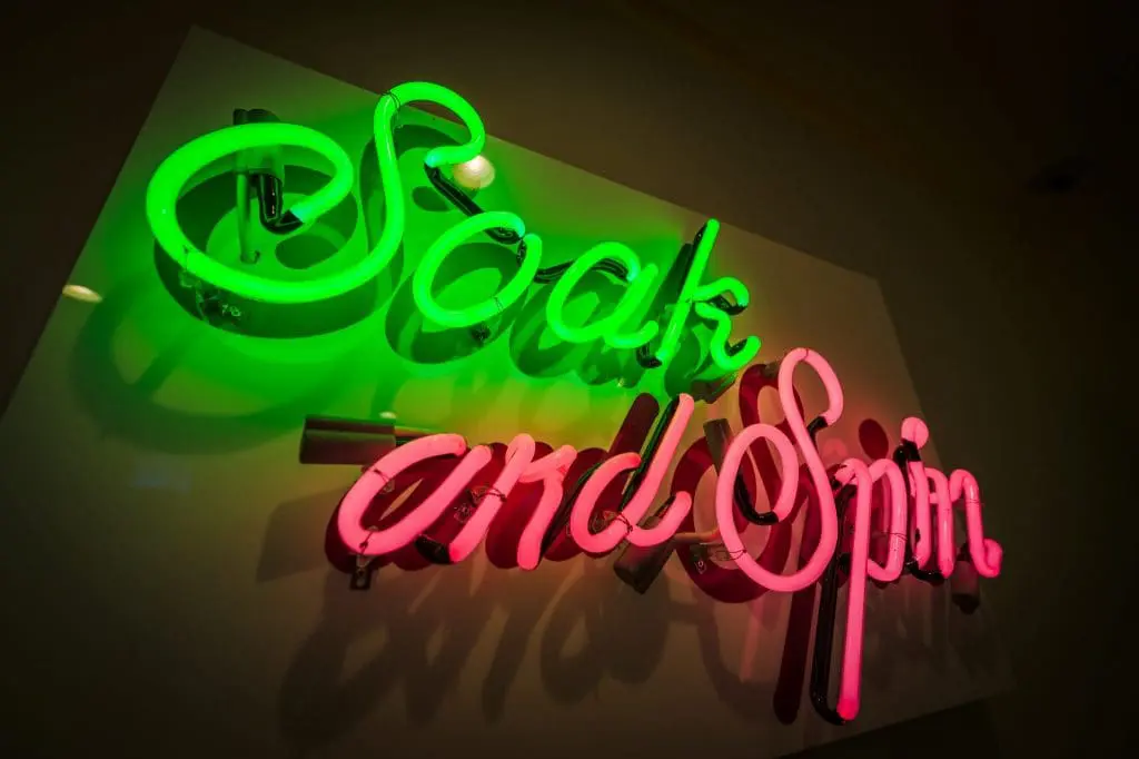 Wash your clothes in style! Fun neon sign designed by Lucy Jones. Photo by John David Helms, www.johndavidhelms.com